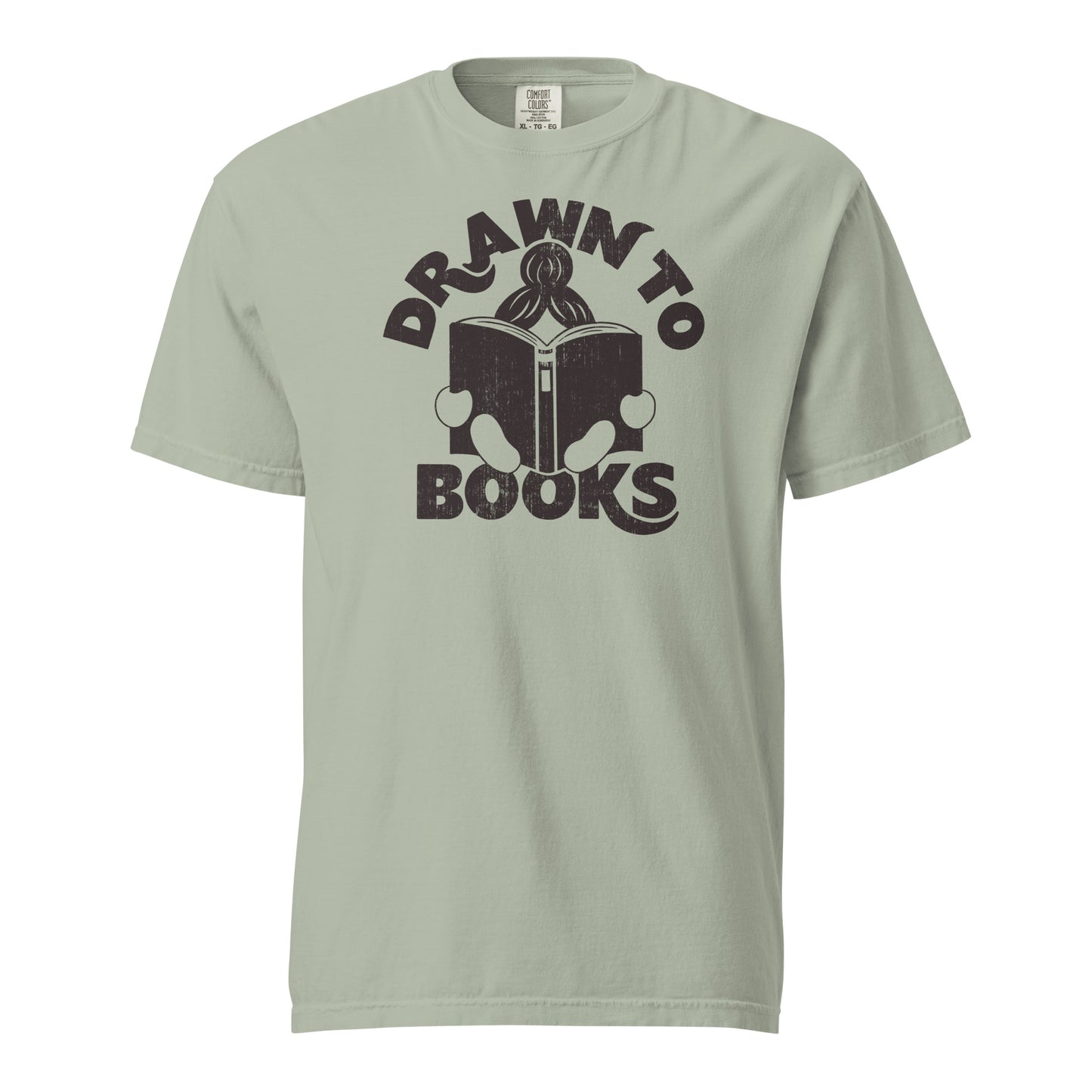 Bay Tan Gray t-shirt with Drawn to Books logo, text says "Drawn to Books" which is framed around a girl reading a book, and you can see only the top of her ponytail, hands and feet, and the big book she's reading.