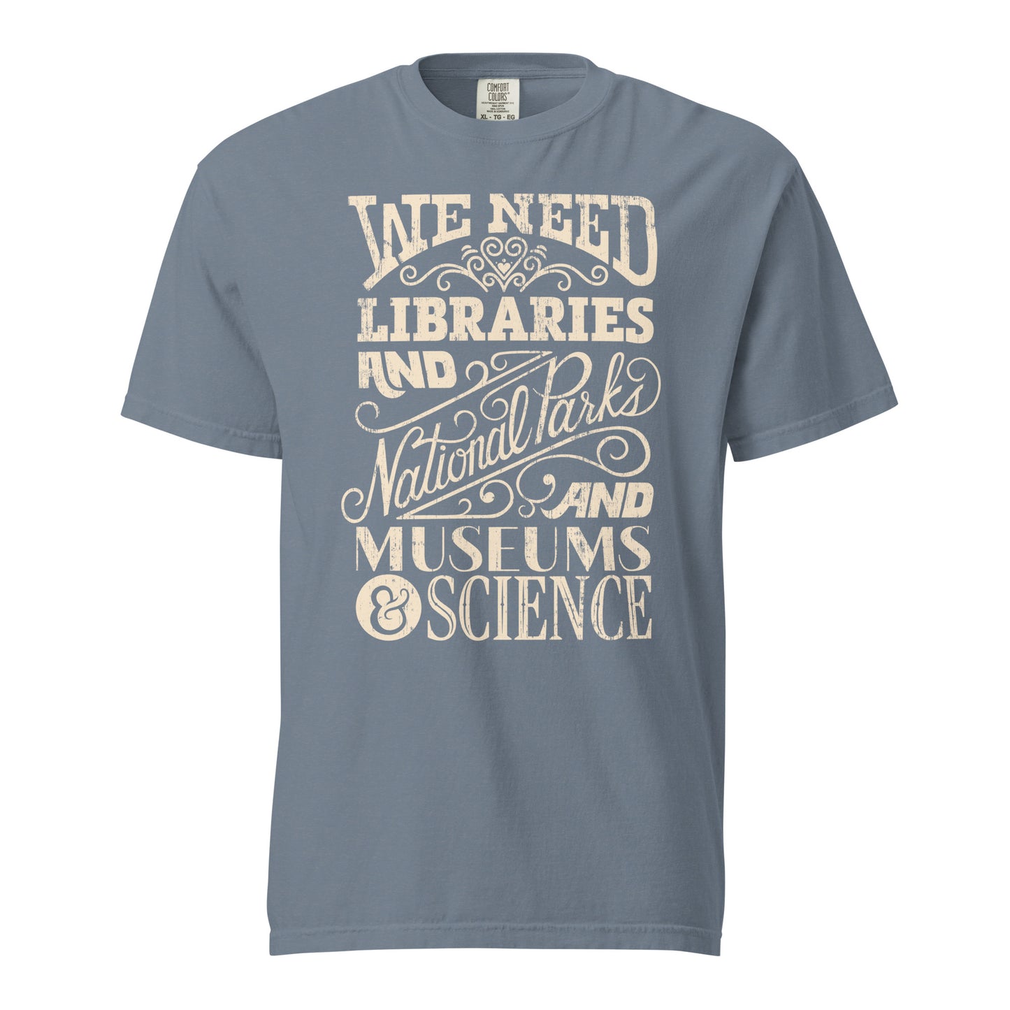 Blue Jean Gray Comfort Colors t-shirt with a hand lettered typography design reading "We Need Libraries and National Parks and Museums and Science."