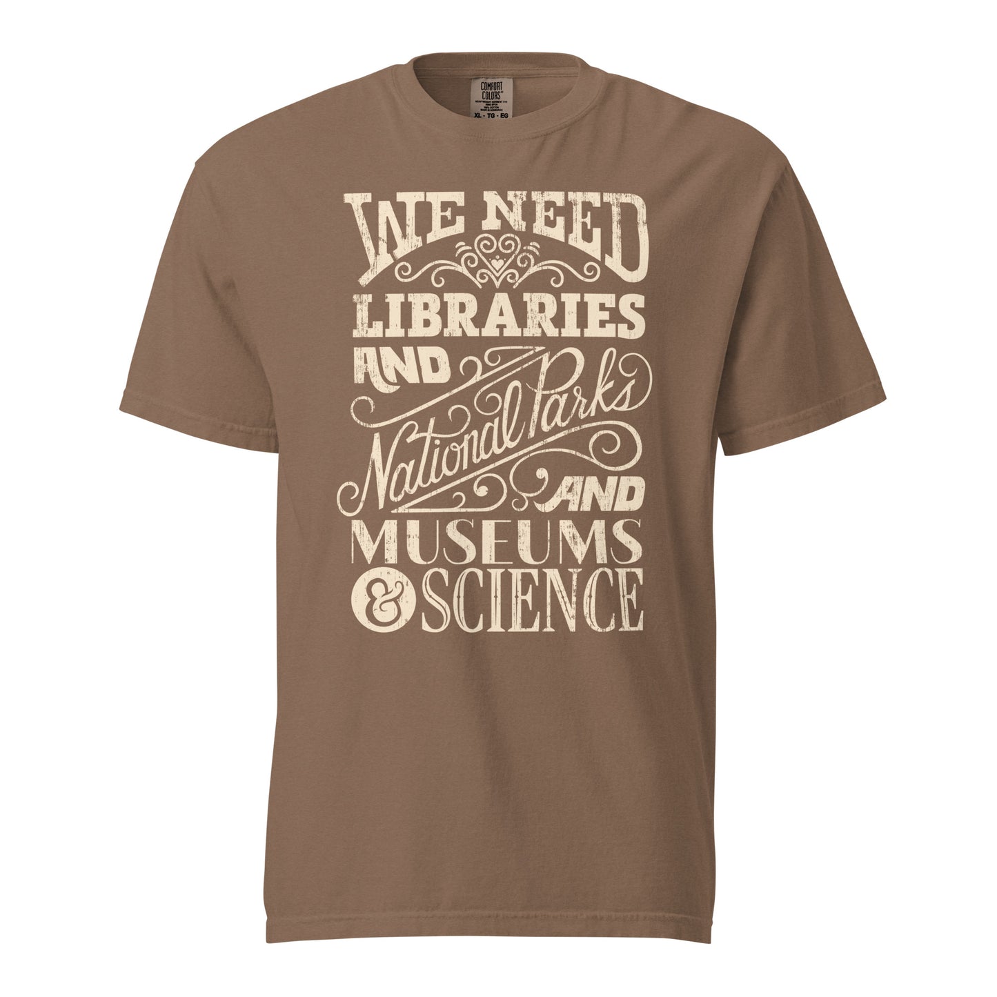 Espresso Brown Comfort Colors t-shirt with a hand lettered typography design reading "We Need Libraries and National Parks and Museums and Science."