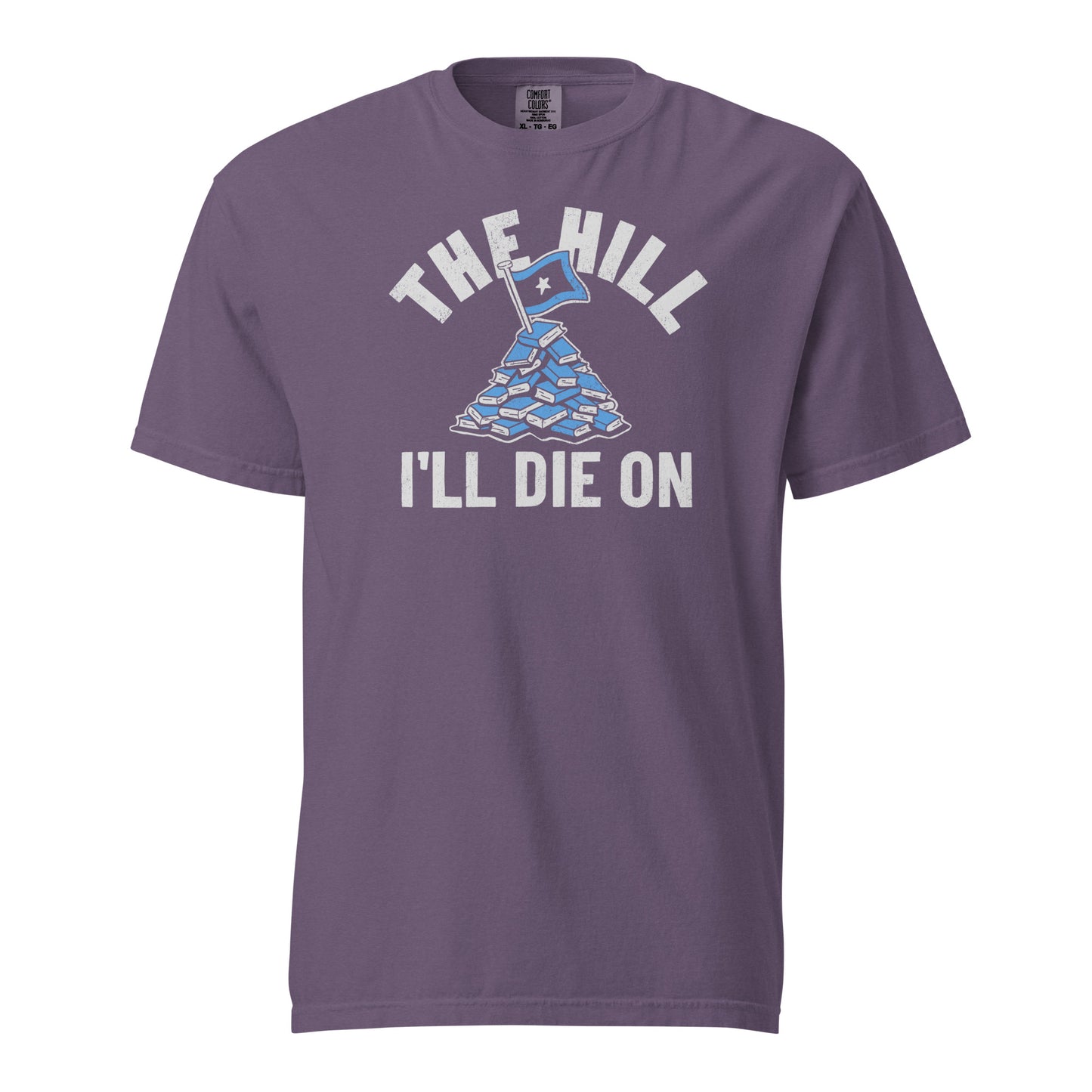Grape Purple Comfort Colors T-shirt with a hand-drawn illustration of a light blue stack of books with the phrase "The Hill I'll Die On."