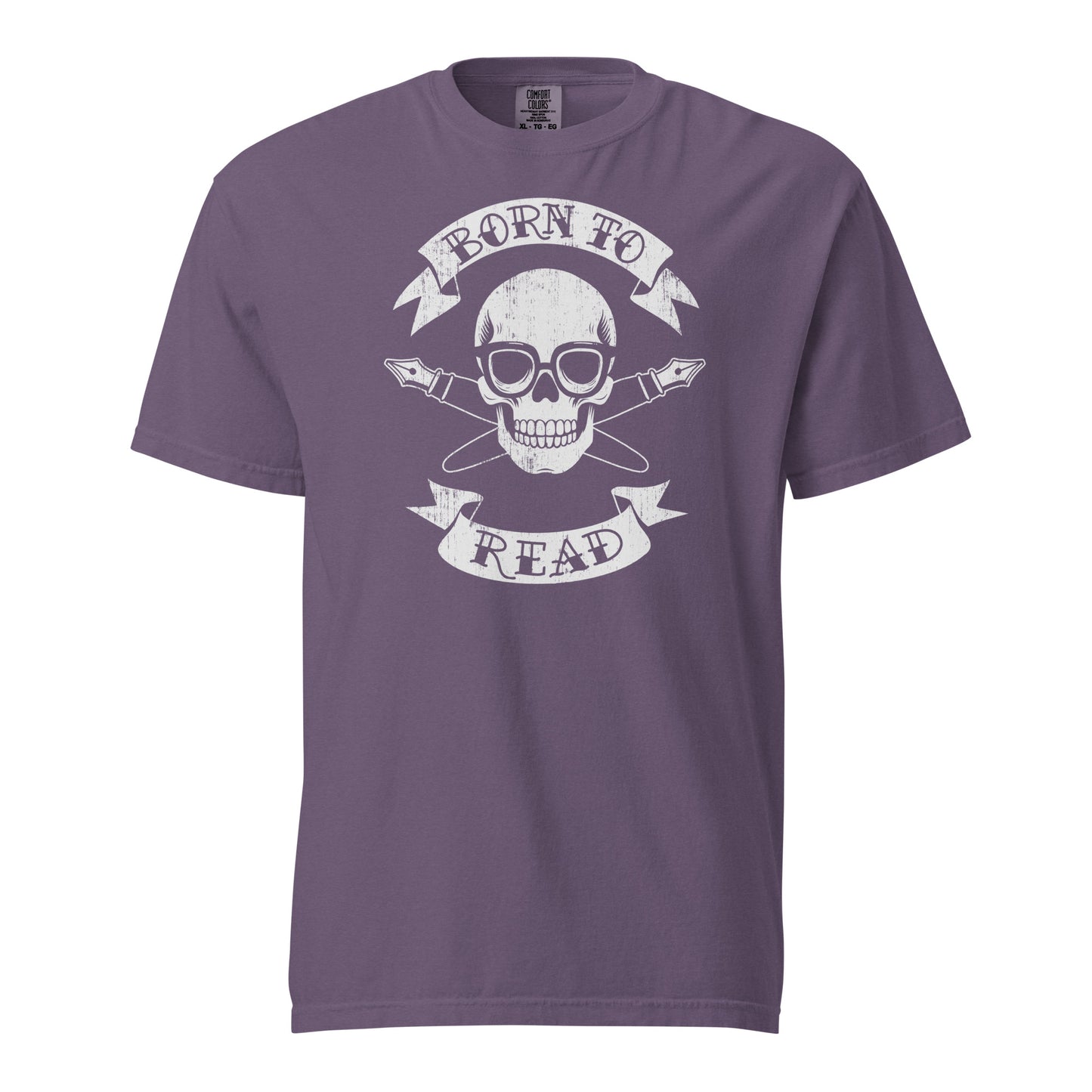 Grape Purple Comfort Colors T-shirt with a hand-drawn illustration of a skull and crossbones, except instead of crossbones, it has crossed pens and he's wearing nerdy glasses. The text is in a banner on top and bottom that reads "Born to Read"
