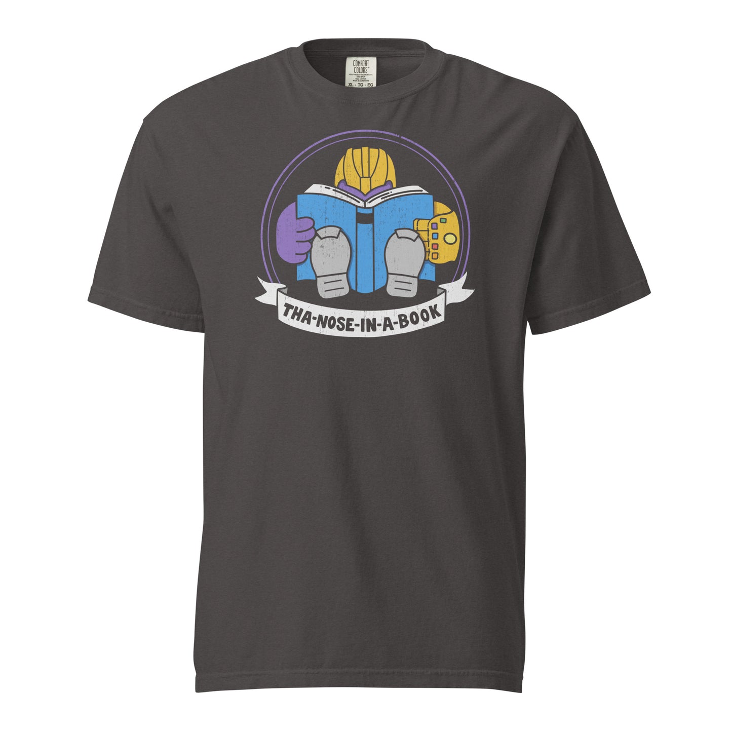 Graphite Comfort Colors t-shirt with a purple villain wearing a gold glove with gemstones. He is reading a blue book and the bottom banner reads "Tha-nose-in-a-book" as a parody.