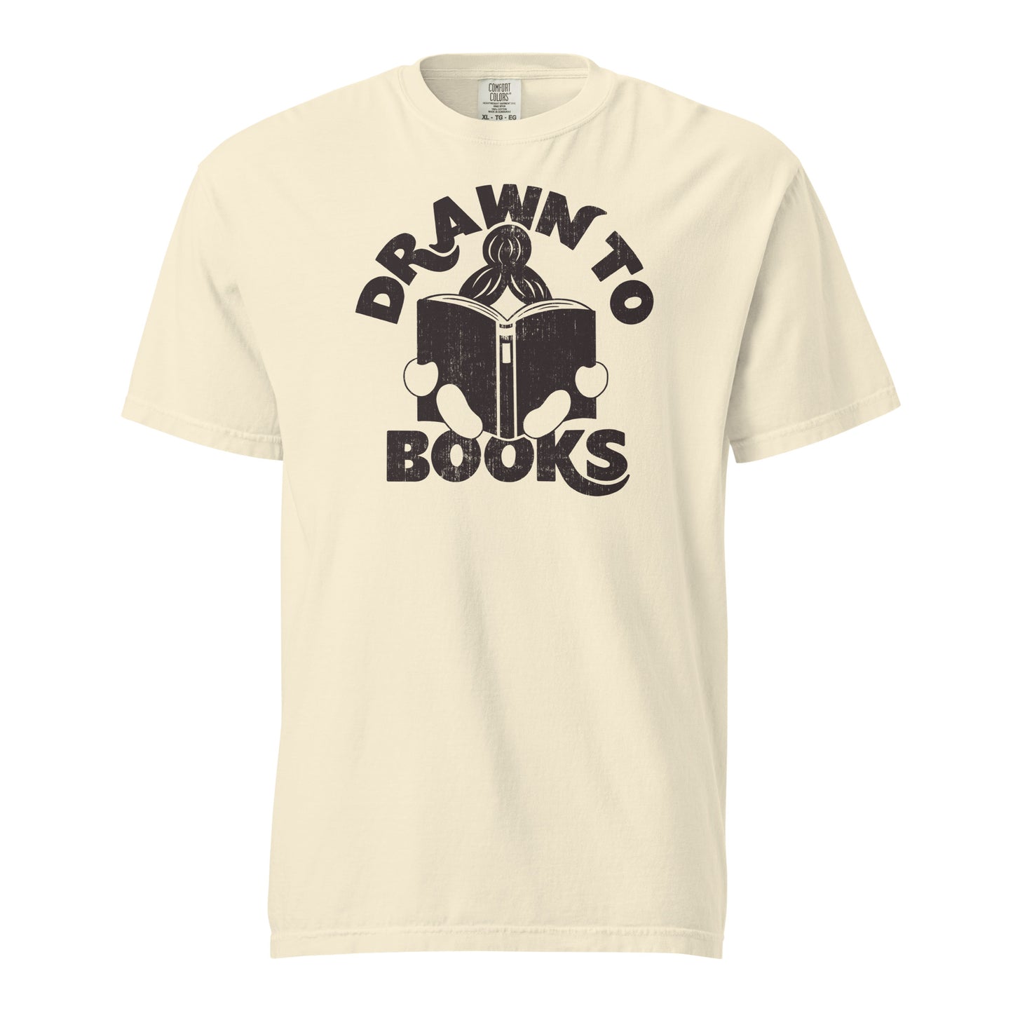 Ivory White t-shirt with Drawn to Books logo, text says "Drawn to Books" which is framed around a girl reading a book, and you can see only the top of her ponytail, hands and feet, and the big book she's reading.