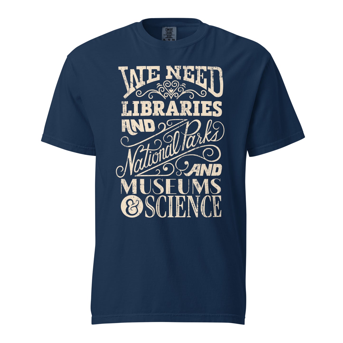 Navy Blue Comfort Colors t-shirt with a hand lettered typography design reading "We Need Libraries and National Parks and Museums and Science."