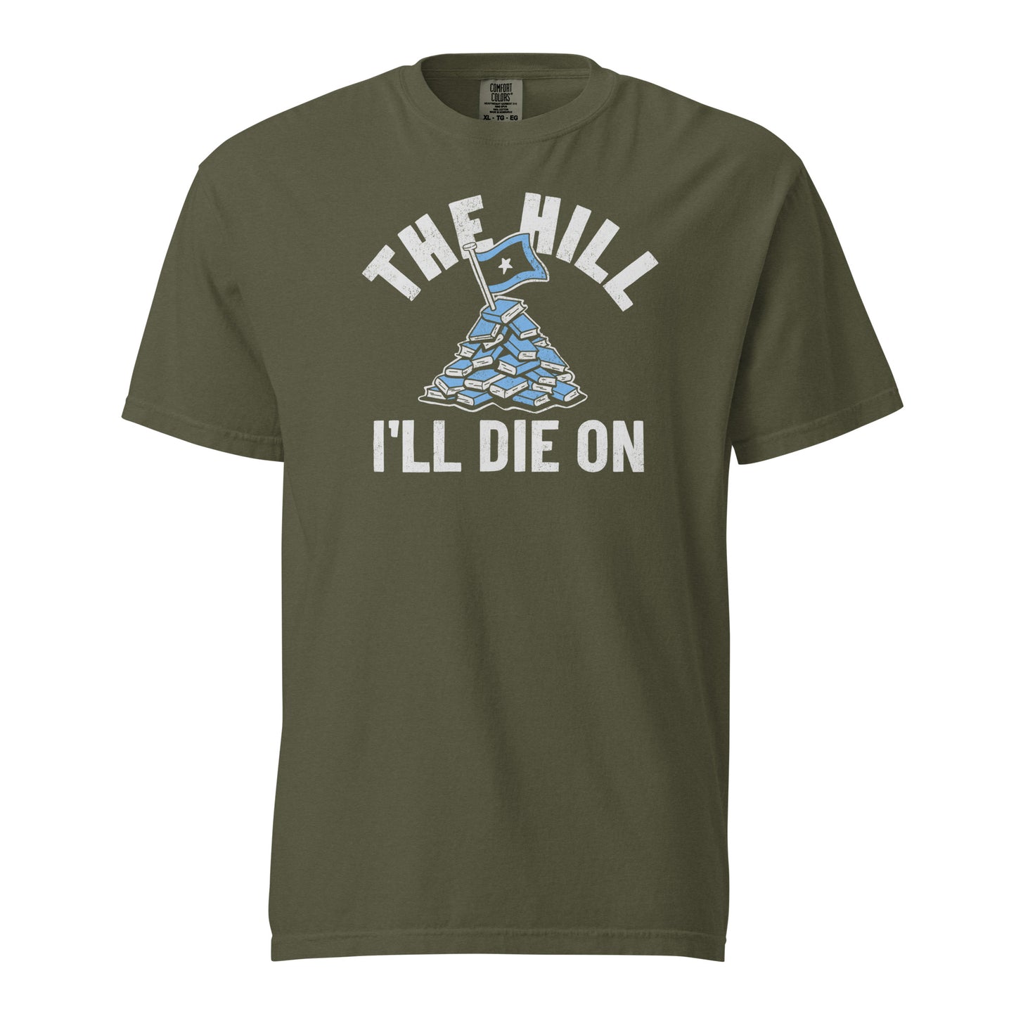 Sage Green Comfort Colors T-shirt with a hand-drawn illustration of a light blue stack of books with the phrase "The Hill I'll Die On."