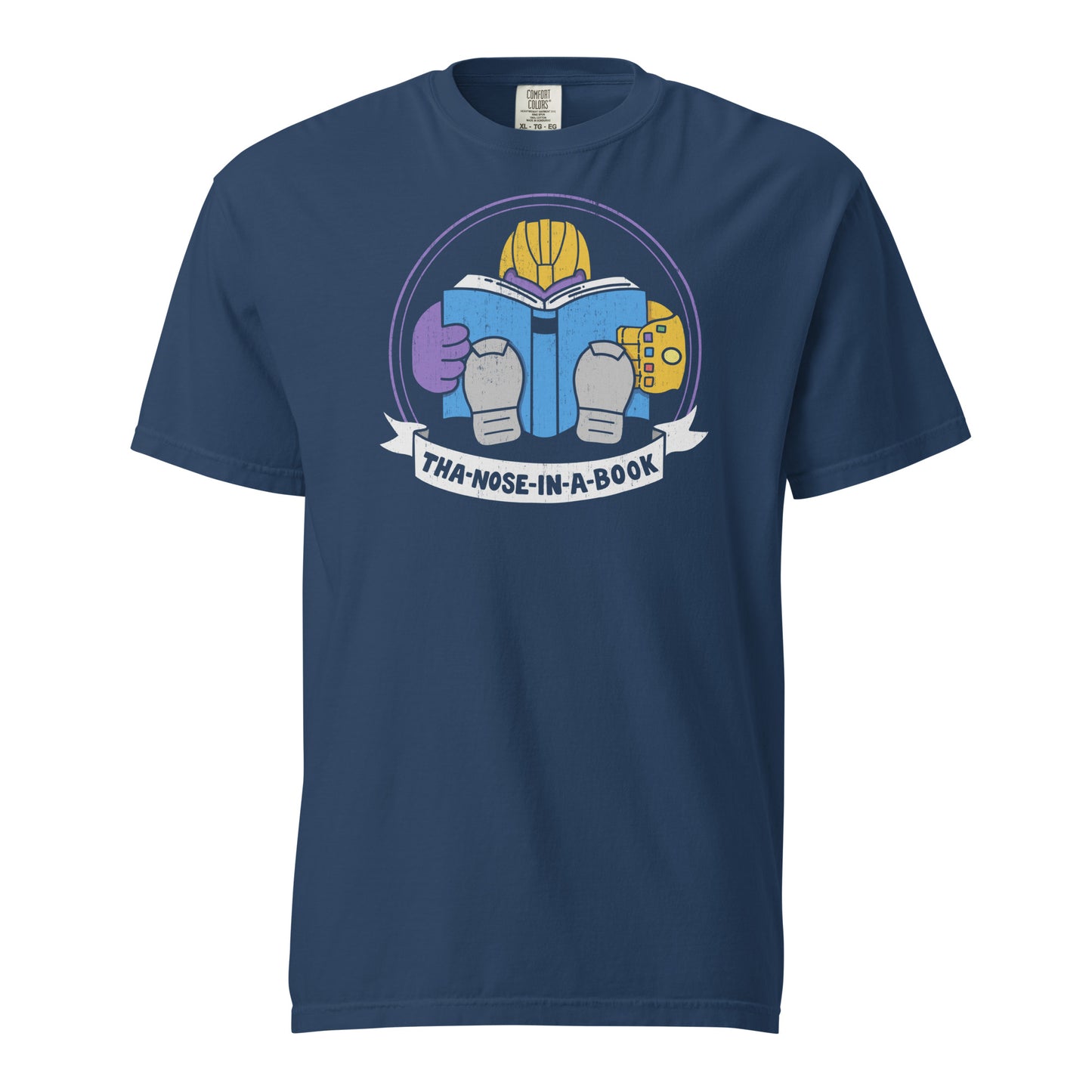 True Navy Blue Comfort Colors t-shirt with a purple villain wearing a gold glove with gemstones. He is reading a blue book and the bottom banner reads "Tha-nose-in-a-book" as a parody.