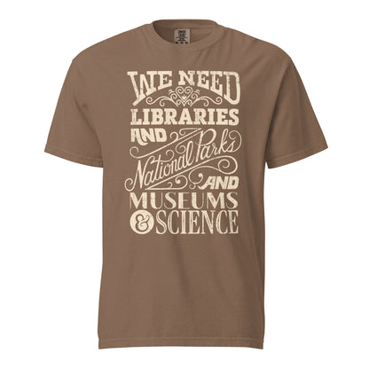 Espresso Brown Comfort Colors t-shirt with a hand lettered typography design reading "We Need Libraries and National Parks and Museums and Science."