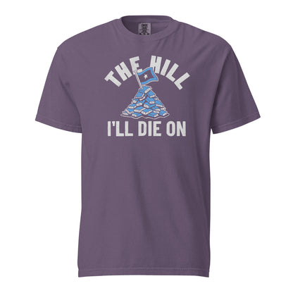 Grape Purple Comfort Colors T-shirt with a hand-drawn illustration of a light blue stack of books with the phrase "The Hill I'll Die On." 