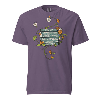 Grape Purple Comfort Colors T-shirt featuring all of Jane Austen's novels with teal covers and hand-type of each title, surrounded by a delicate floral design with white and orange flowers and green vines.