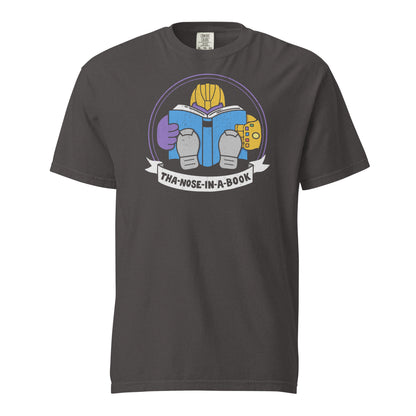 Graphite Comfort Colors t-shirt with a purple villain wearing a gold glove with gemstones. He is reading a blue book and the bottom banner reads "Tha-nose-in-a-book" as a parody.