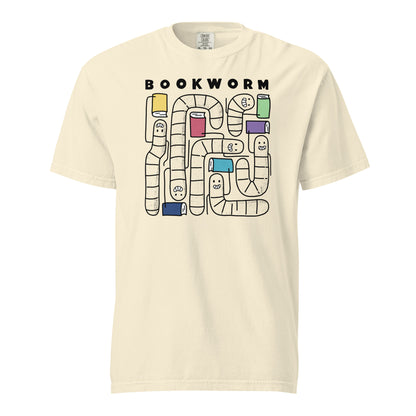 Ivory White Comfort Colors t-shirt with 'Bookworm' design, features a hand-drawn design with black outlined worms and happy faces . Each worm is holding up a book.